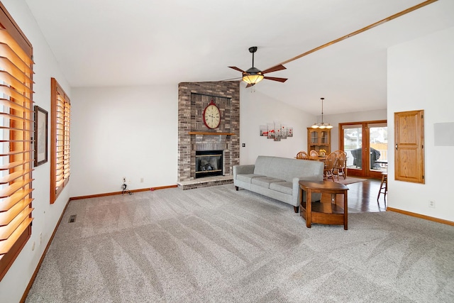 unfurnished living room with carpet floors, french doors, a fireplace, lofted ceiling, and ceiling fan