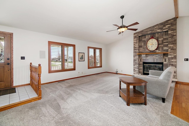 living room with visible vents, a brick fireplace, baseboards, a ceiling fan, and vaulted ceiling