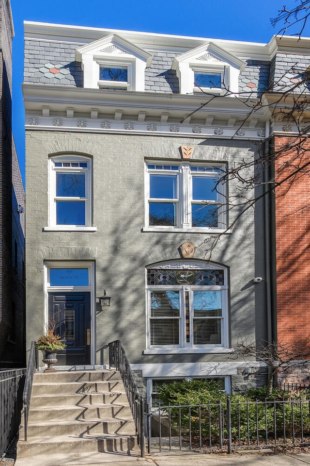 2115 N Fremont St, Chicago, IL 60614 - view of front of home with a fenced front yard and mansard roof