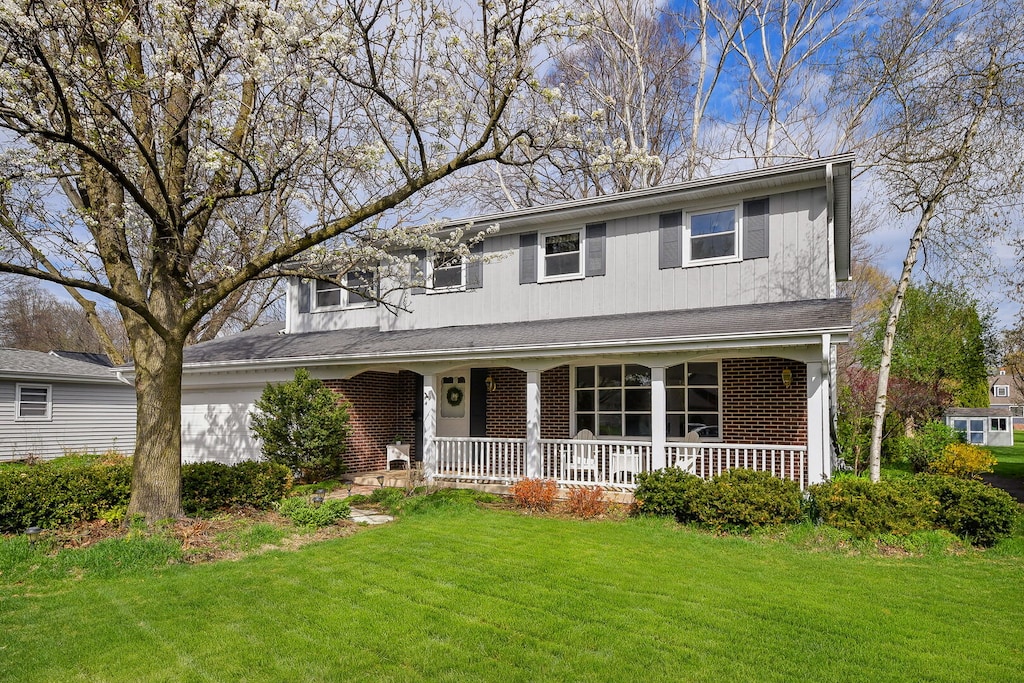 1214 S 6th St, Saint Charles, IL 60174 - traditional-style house featuring a porch, brick siding, and a front yard