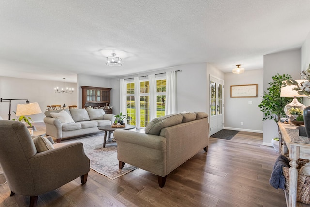 15 Wood Ln, Monticello, IL 61856 - living area with baseboards, a textured ceiling, a chandelier, and dark wood finished floors