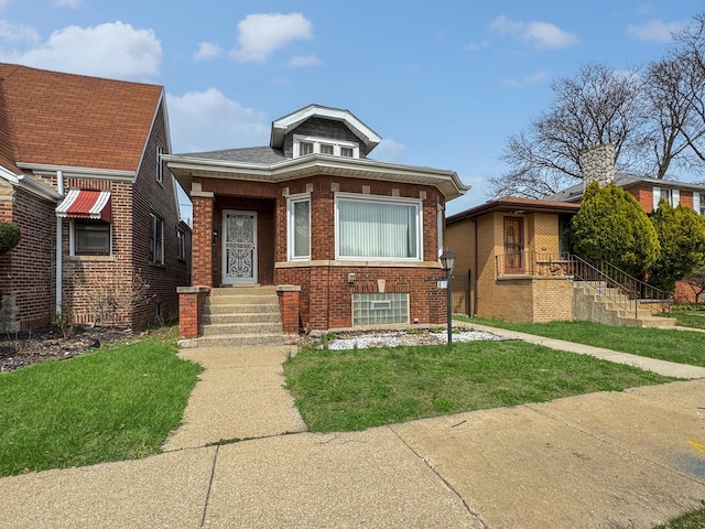 608 W 107th St, Chicago, IL 60628 - bungalow featuring brick siding and a front yard