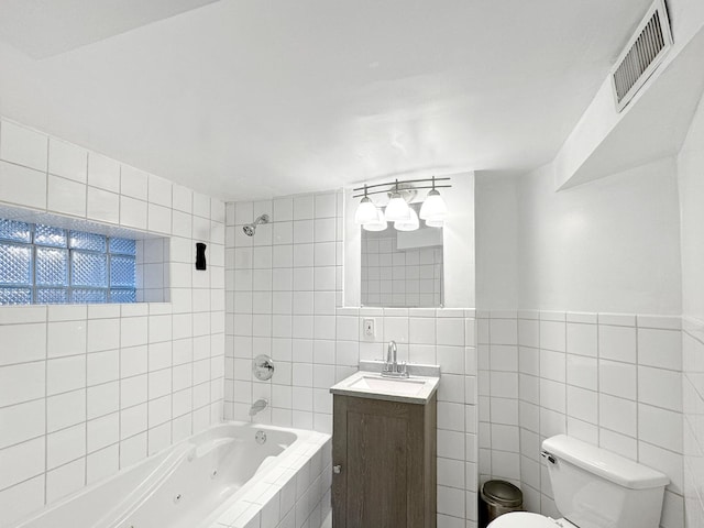608 W 107th St, Chicago, IL 60628 - full bathroom with tile walls, a combined bath / shower with jetted tub, toilet, and vanity