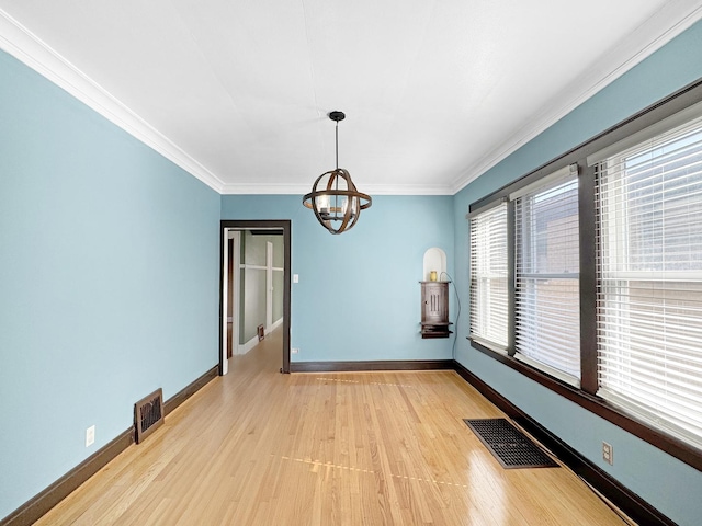 608 W 107th St, Chicago, IL 60628 - unfurnished dining area featuring a chandelier, light wood finished floors, crown molding, and baseboards