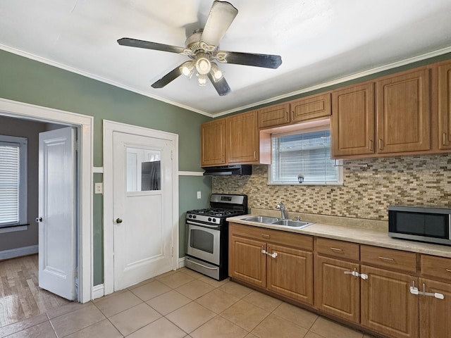 608 W 107th St, Chicago, IL 60628 - kitchen featuring appliances with stainless steel finishes, a sink, backsplash, light countertops, and crown molding
