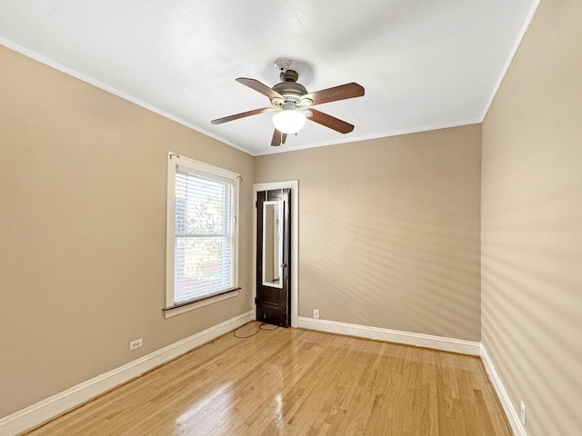 608 W 107th St, Chicago, IL 60628 - empty room featuring light wood-style flooring, baseboards, ornamental molding, and a ceiling fan