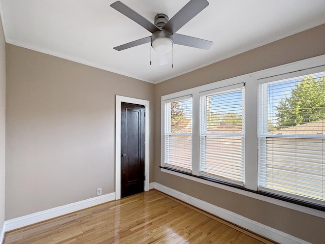608 W 107th St, Chicago, IL 60628 - unfurnished room featuring baseboards, crown molding, light wood finished floors, and a ceiling fan