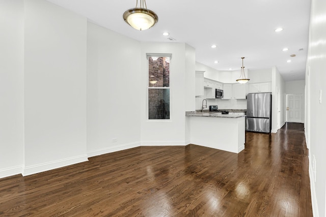 kitchen with stainless steel appliances, recessed lighting, dark wood-style floors, and white cabinetry