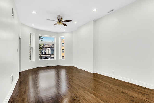 unfurnished room with dark wood-style flooring, a ceiling fan, visible vents, and recessed lighting