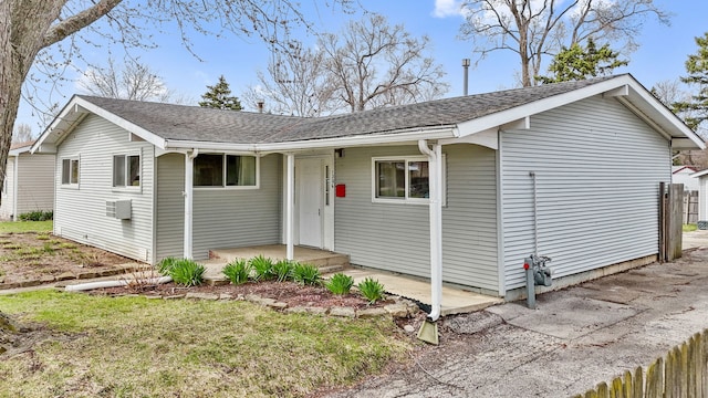 single story home with fence and roof with shingles