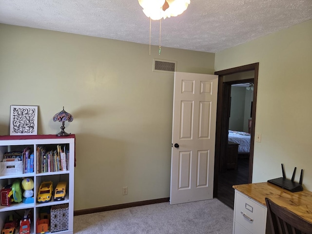 interior space with light carpet, visible vents, a textured ceiling, and baseboards