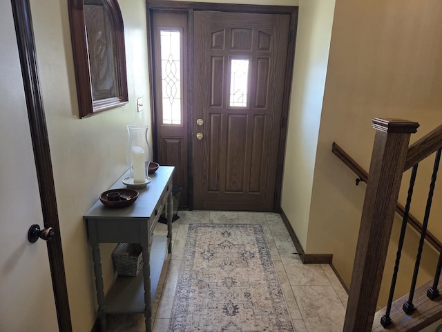 foyer entrance featuring baseboards