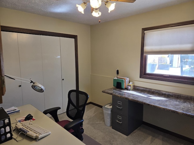 office area featuring a chandelier, a textured ceiling, and carpet floors