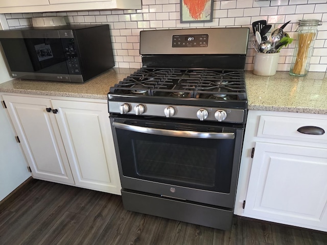 kitchen featuring backsplash, white cabinets, and stainless steel appliances