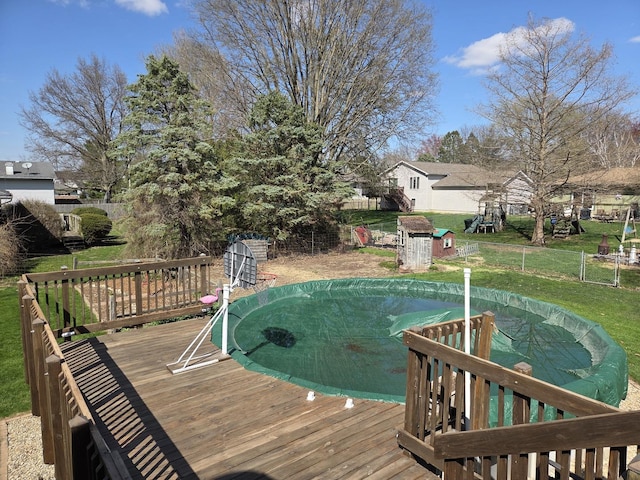 wooden deck with fence and a lawn