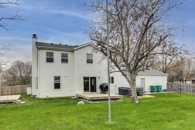 367 Quist Ct, Grayslake, IL 60030 - rear view of property with a chimney, a fenced backyard, a lawn, a hot tub, and a deck