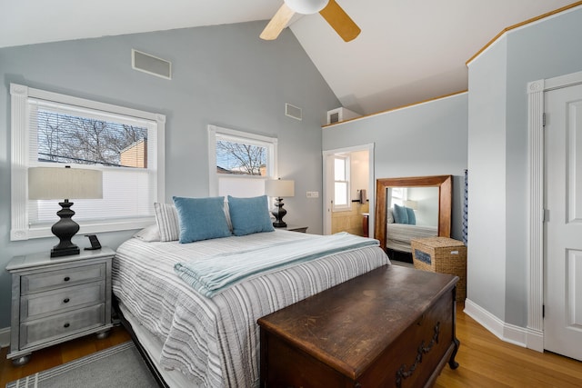 bedroom featuring visible vents, baseboards, and wood finished floors