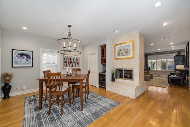 dining space with a chandelier, light wood finished floors, and recessed lighting