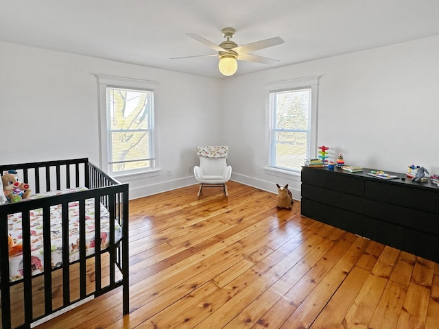 17128 Lukens Rd, Sycamore, IL 60178 - bedroom with light wood-type flooring, a crib, and baseboards