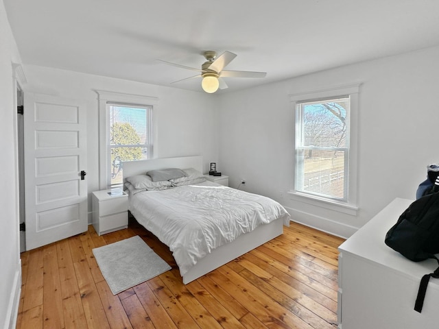 17128 Lukens Rd, Sycamore, IL 60178 - bedroom featuring multiple windows, light wood-style floors, and ceiling fan