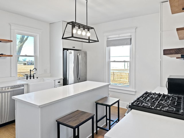 17128 Lukens Rd, Sycamore, IL 60178 - kitchen with stainless steel appliances, open shelves, a sink, and white cabinets