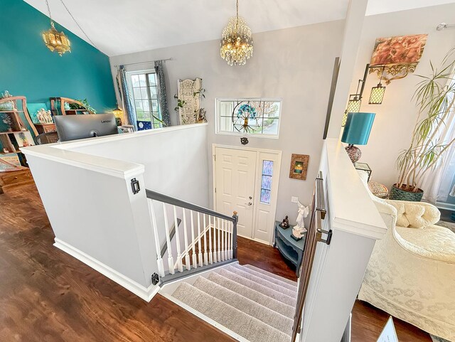 648 S Rosehall Ln, Round Lake, IL 60073 - entrance foyer featuring an inviting chandelier, vaulted ceiling, and wood finished floors