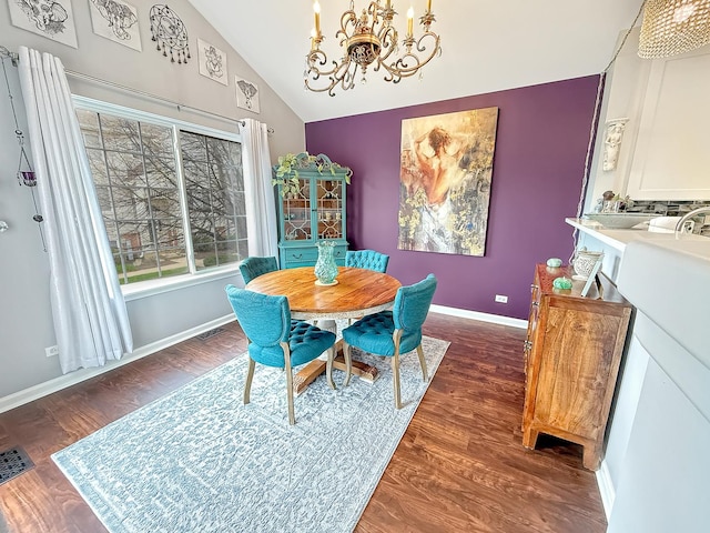 648 S Rosehall Ln, Round Lake, IL 60073 - dining space featuring an inviting chandelier, baseboards, dark wood finished floors, and lofted ceiling