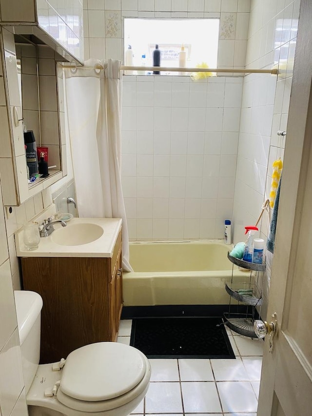 bathroom featuring vanity, tile patterned floors, toilet, and shower / tub combo with curtain