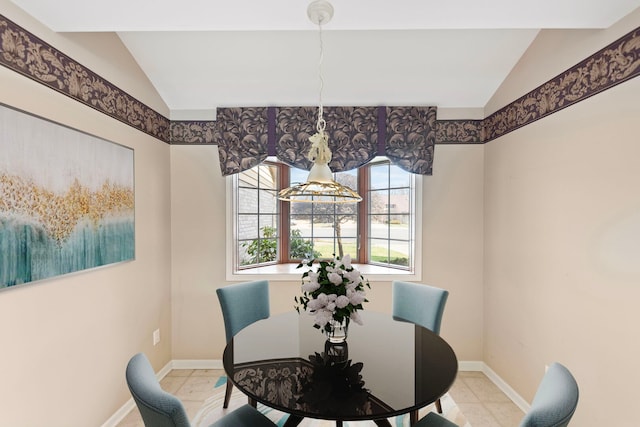 dining space with baseboards, tile patterned flooring, and lofted ceiling