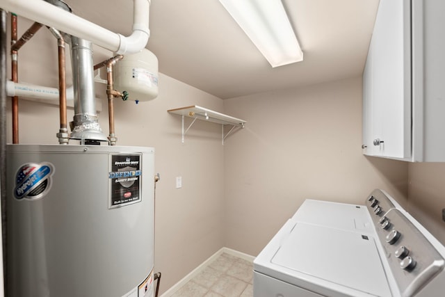 laundry room with water heater, independent washer and dryer, cabinet space, and baseboards