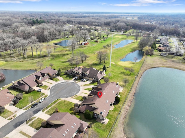drone / aerial view with a residential view and a water view