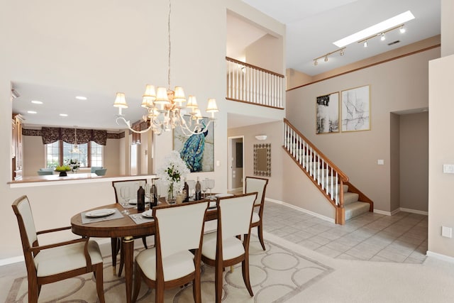 dining room featuring track lighting, baseboards, an inviting chandelier, stairway, and recessed lighting