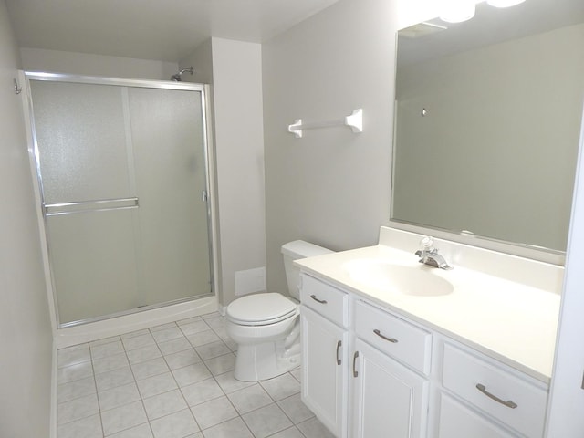 bathroom with a shower stall, toilet, tile patterned flooring, and vanity