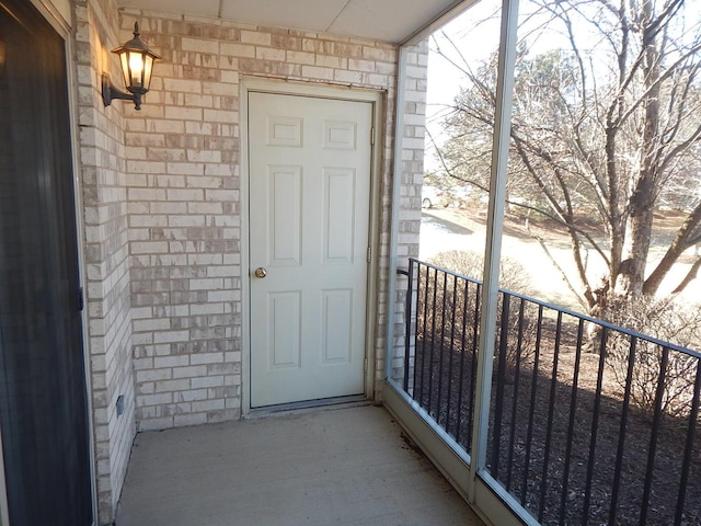 doorway to property with brick siding