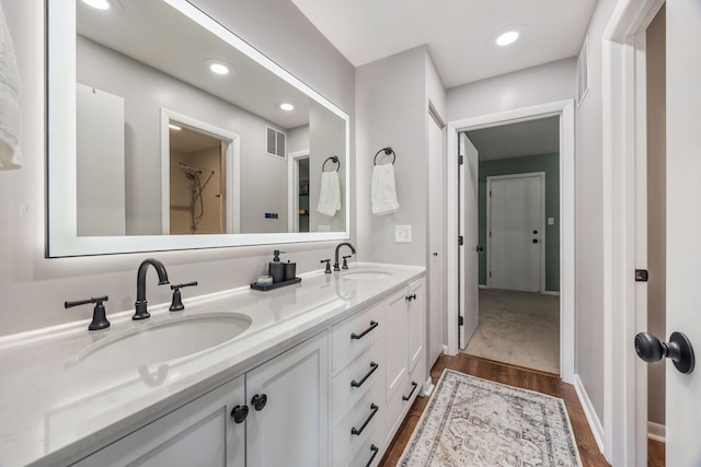 849 W Buckingham Pl Unit G, Chicago, IL 60657 - bathroom featuring a sink, double vanity, wood finished floors, and visible vents