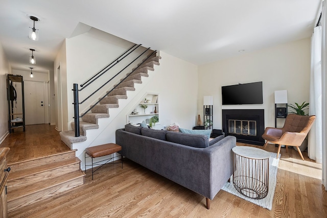 849 W Buckingham Pl Unit G, Chicago, IL 60657 - living room with stairs, baseboards, a fireplace with flush hearth, and light wood finished floors