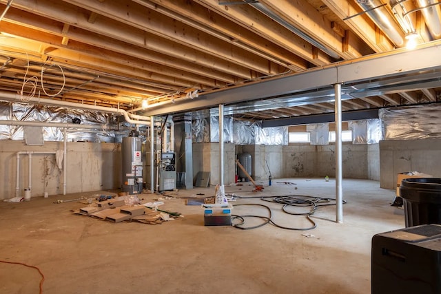 below grade area featuring water heater and heating unit