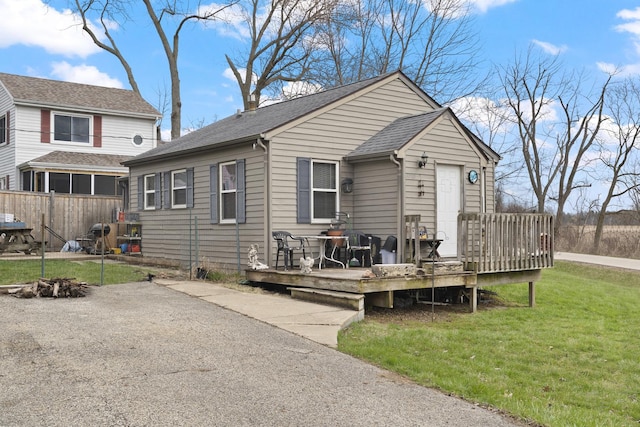 37115 N Sistina Ave, Lake Villa, IL 60046 - view of front of house with a front lawn, fence, a deck, and roof with shingles