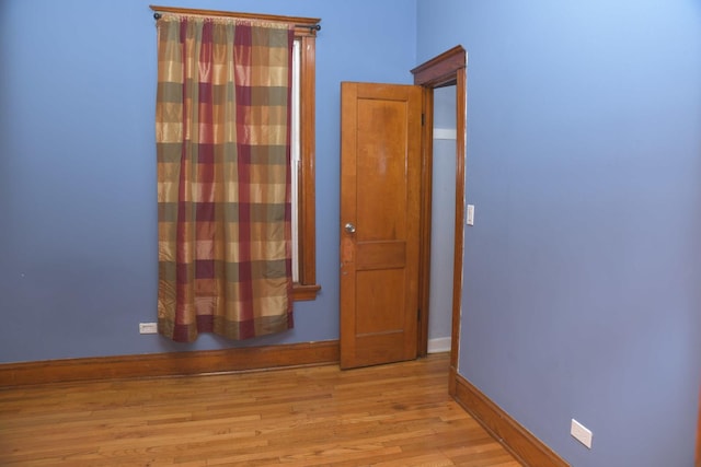 empty room featuring baseboards and wood finished floors