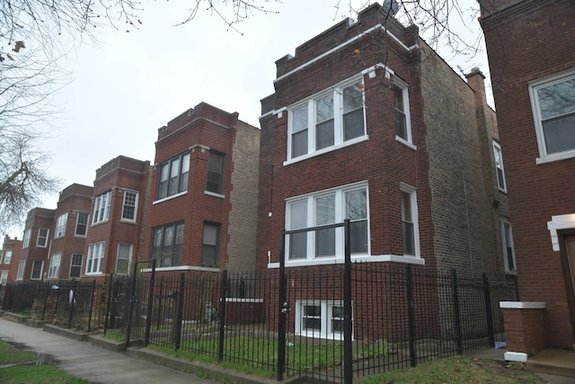 view of building exterior with a fenced front yard