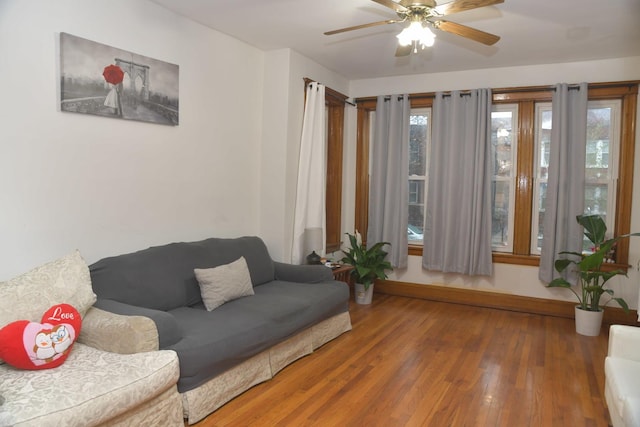 living room with ceiling fan and wood finished floors