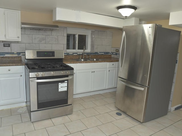 kitchen featuring a sink, backsplash, appliances with stainless steel finishes, under cabinet range hood, and white cabinets