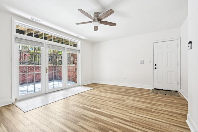4310 N Richmond St Unit 1, Chicago, IL 60618 - empty room featuring light wood-type flooring, ceiling fan, and baseboards