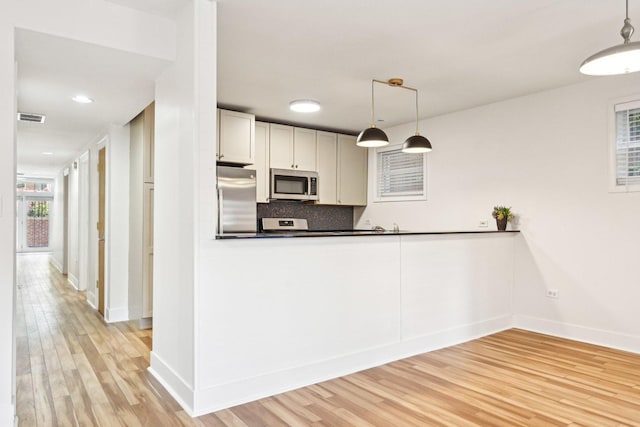 4310 N Richmond St Unit 1, Chicago, IL 60618 - kitchen featuring appliances with stainless steel finishes, light wood-type flooring, baseboards, and decorative backsplash