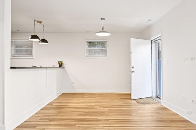4310 N Richmond St Unit 1, Chicago, IL 60618 - unfurnished dining area featuring light wood-style floors and baseboards