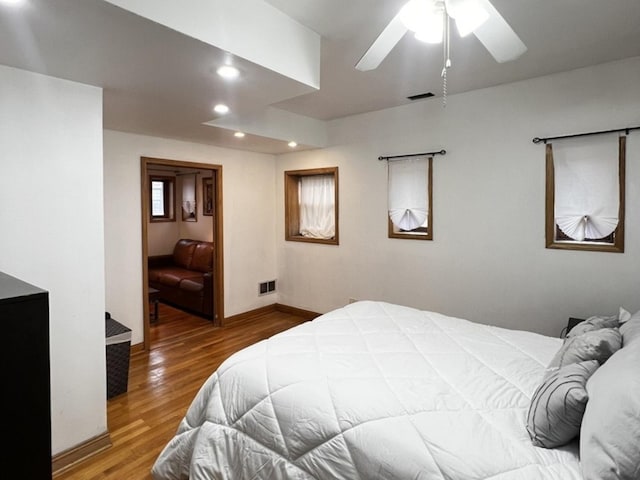 bedroom featuring recessed lighting, baseboards, visible vents, ceiling fan, and wood finished floors