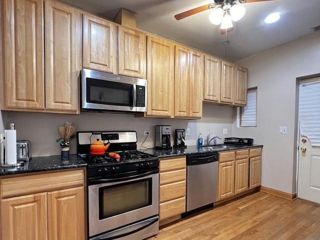 kitchen with light brown cabinetry, light wood-style floors, a ceiling fan, and appliances with stainless steel finishes