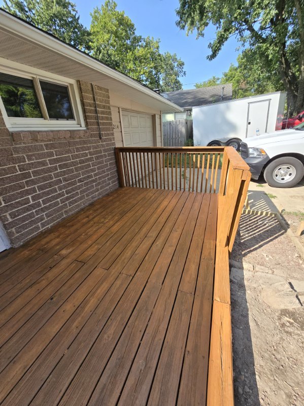 214 Augusta Dr, Mahomet, IL 61853 - wooden deck with fence and an attached garage