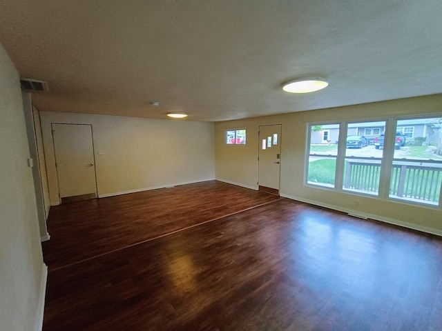 214 Augusta Dr, Mahomet, IL 61853 - foyer featuring visible vents, baseboards, and dark wood finished floors