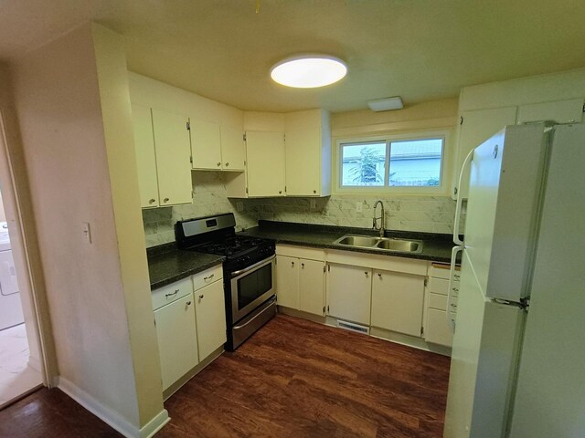 214 Augusta Dr, Mahomet, IL 61853 - kitchen featuring freestanding refrigerator, dark countertops, a sink, and stainless steel range with gas cooktop